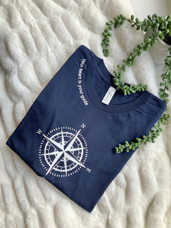 Compass navy blue short sleeve t-shirt with wordings near the neck line “Your Heart is Your Guide”.